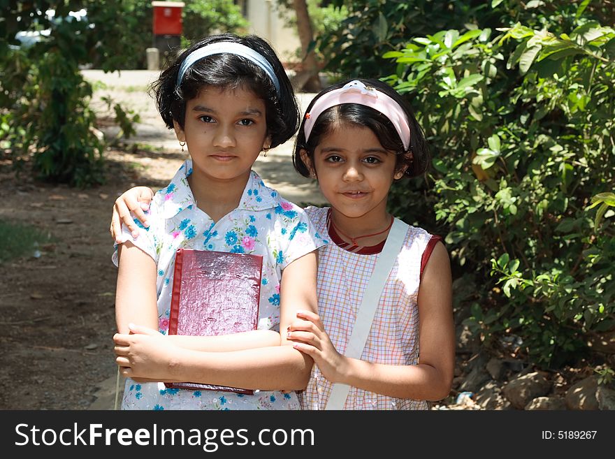 A portrait of two active and smart Indian girls. A portrait of two active and smart Indian girls.