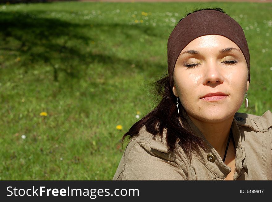 Attractive woman relaxing on green grass. Attractive woman relaxing on green grass