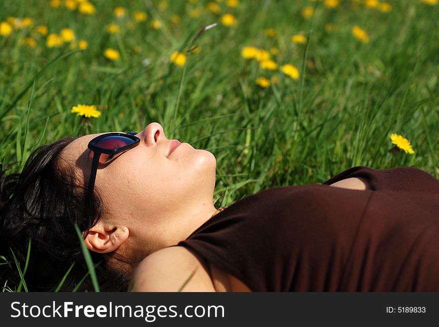 Attractive woman relaxing on green grass. Attractive woman relaxing on green grass