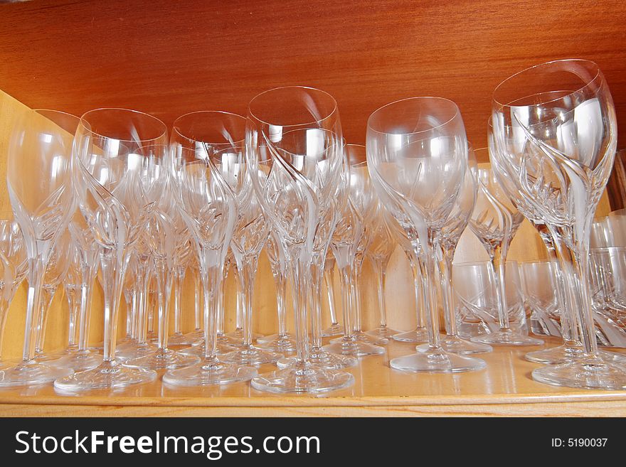 Crystal wine glasses arranged in a cupboard. Crystal wine glasses arranged in a cupboard