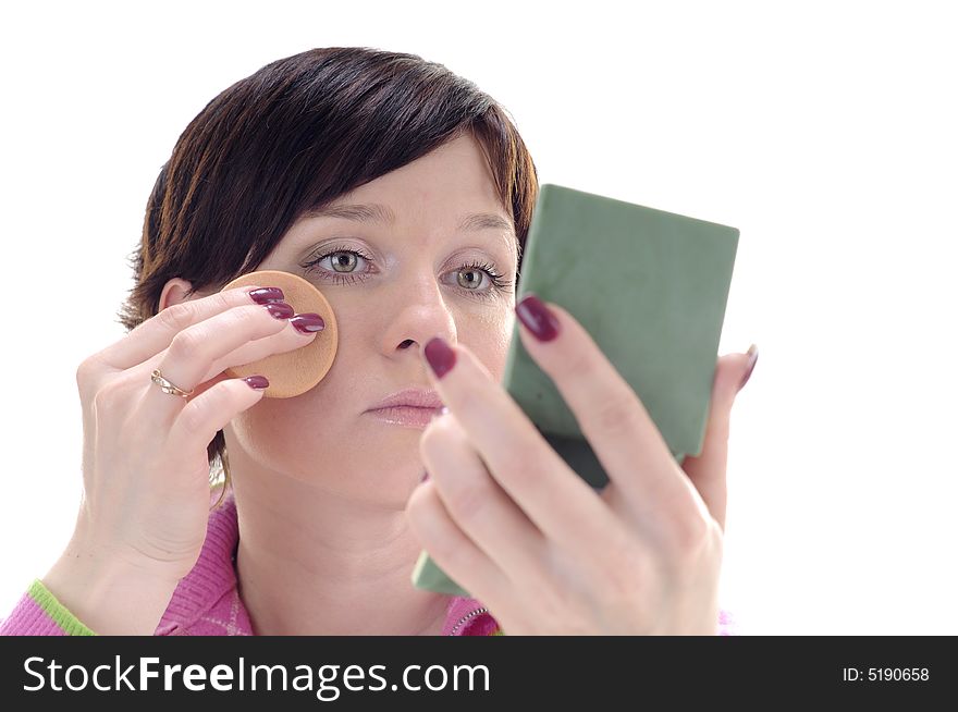 Young woman put beauty make-up on face