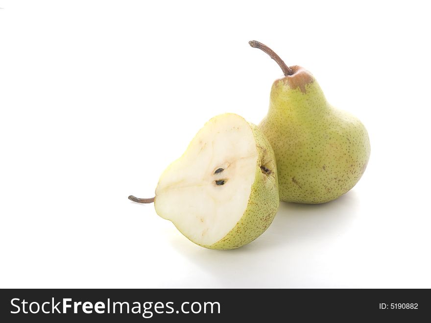 Green pears on the white background. One half and one full pear.