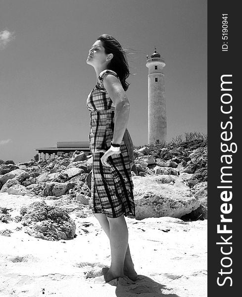 The girl standing by the lighthouse in Punta Sur Eco Park on Cozumel island, Mexico.