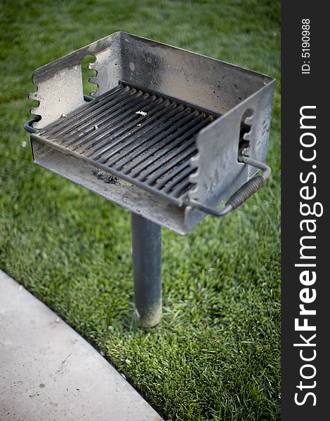 High-angle view of barbecue grill in park with green grass background