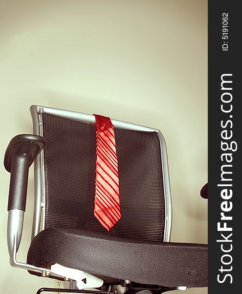 Red tie on business chair in office