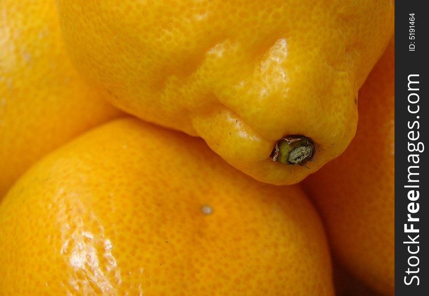 The large ripe juicy oranges with a yellow leather(skin) lay in a straw plate. The large ripe juicy oranges with a yellow leather(skin) lay in a straw plate