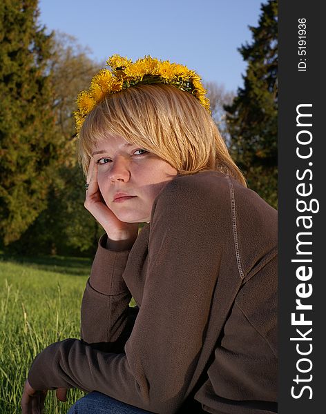 Worried blond hair woman in dandelions garland. Worried blond hair woman in dandelions garland