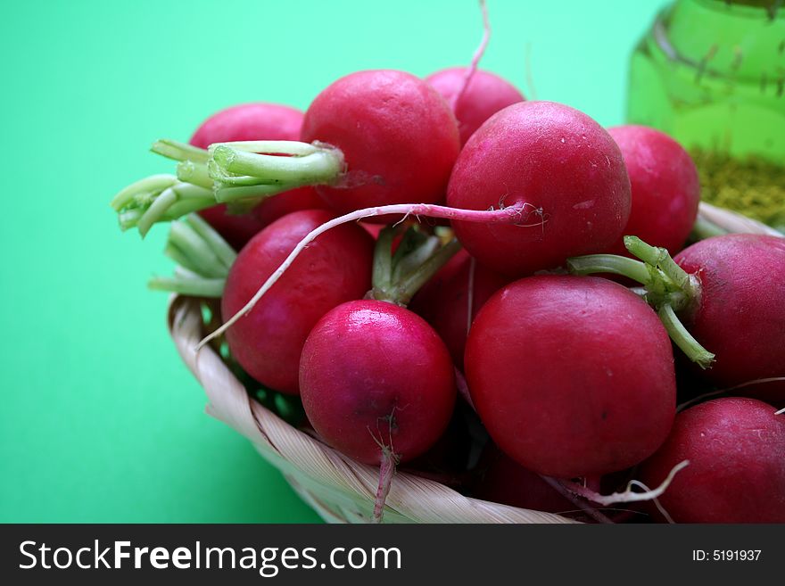 Some fresh red radishes in a basket