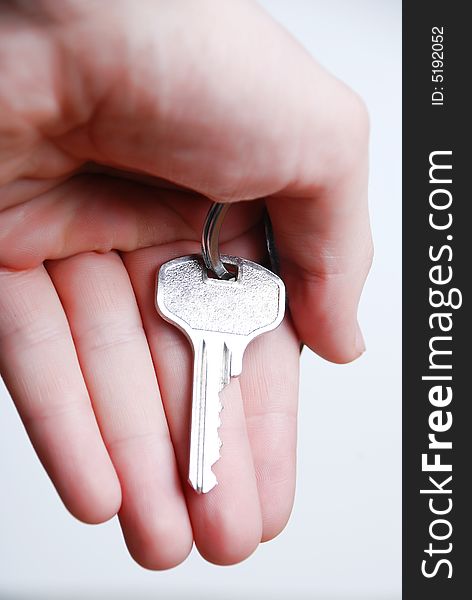 Key from house in hand at white background. Key from house in hand at white background