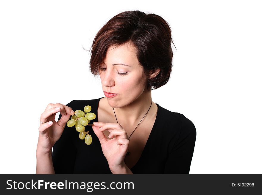Girl on diet sceptically look on grape. Girl on diet sceptically look on grape