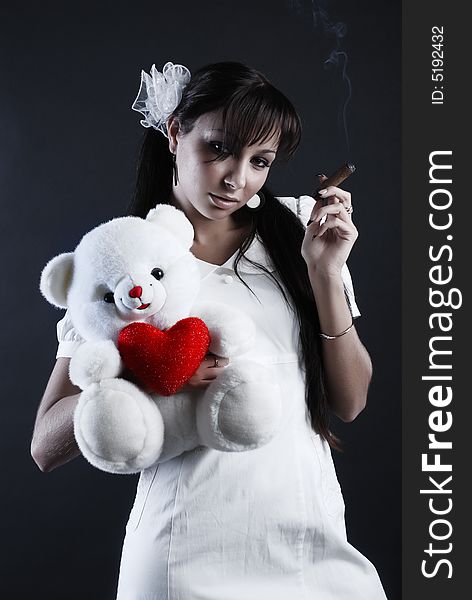 Beauty portrait of woman at black background with toy and cigare. Beauty portrait of woman at black background with toy and cigare