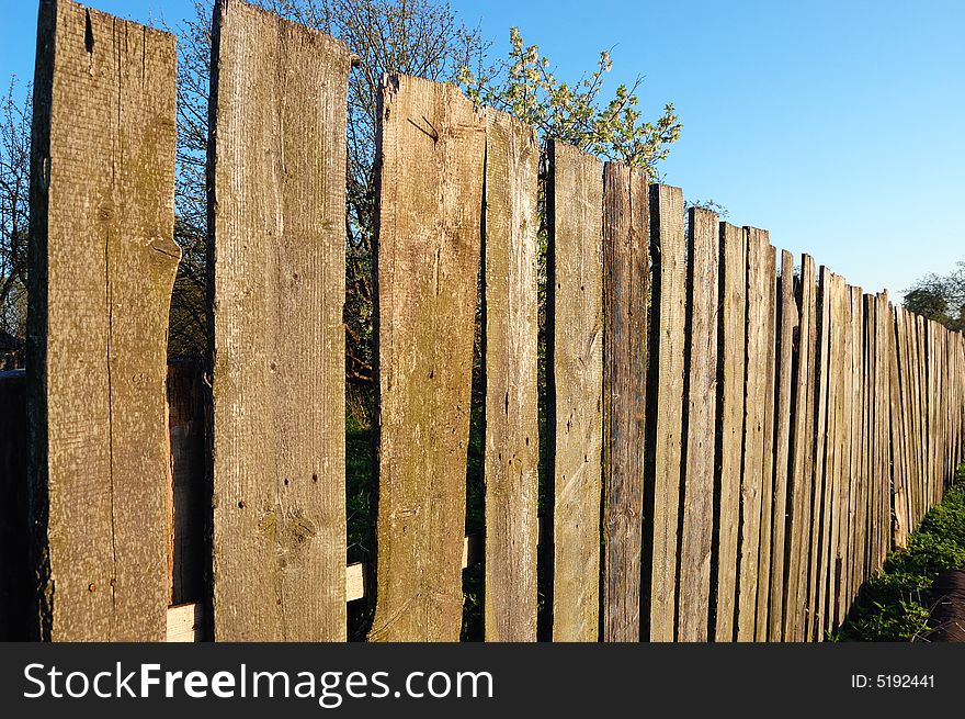 Old wooden fence over a blue sky