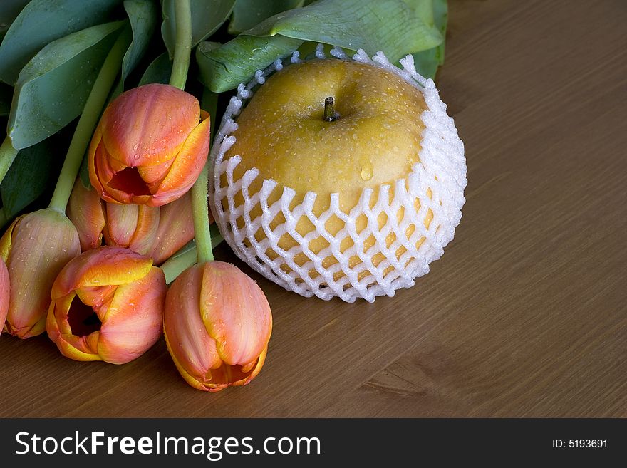 Asian (Nashi) Pear On Wood Table With Orange Tulip