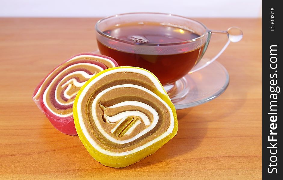 Colorful fruit candy and cup of tea. Colorful fruit candy and cup of tea