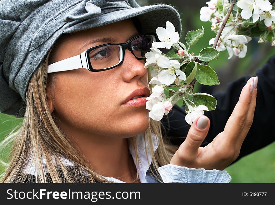 Portrait of pretty girl in the flowering garden