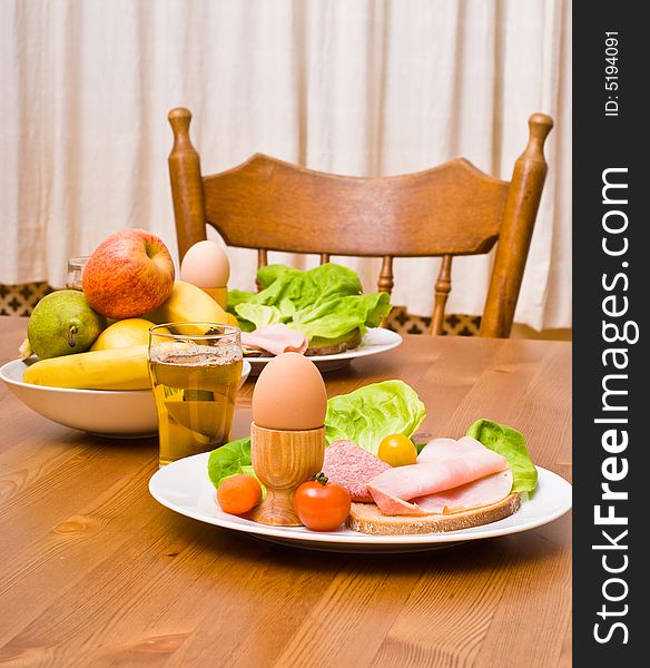 Table served with snacks. Fruits, vegetables, bread, egg, ham etc. Table served with snacks. Fruits, vegetables, bread, egg, ham etc.