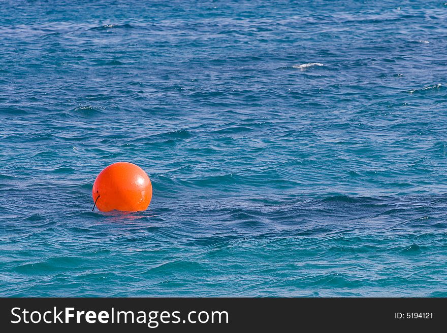 Red ball or balloon on the sea as the background. Red ball or balloon on the sea as the background