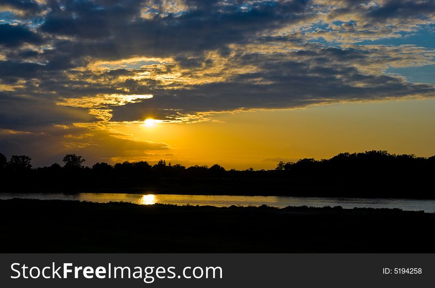Sky with sun and clouds over Loire river, France