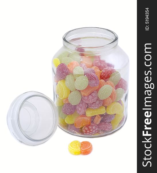 Multicolor bonbons in glass pot on the white background