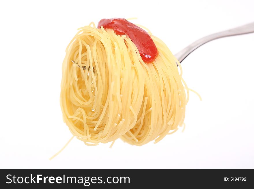 Spaghetti on a fork with ketchup