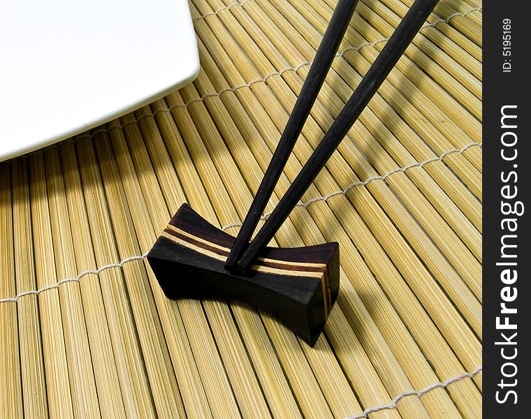 Chopsticks and bamboo mat close up