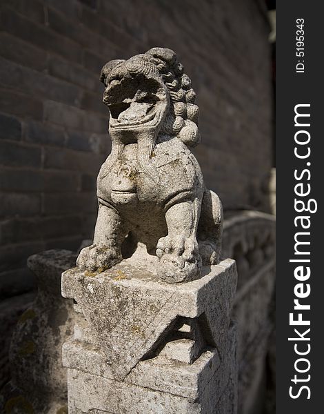 Stone sculpture lion at Chinaï¼Œisolated. Stone sculpture lion at Chinaï¼Œisolated