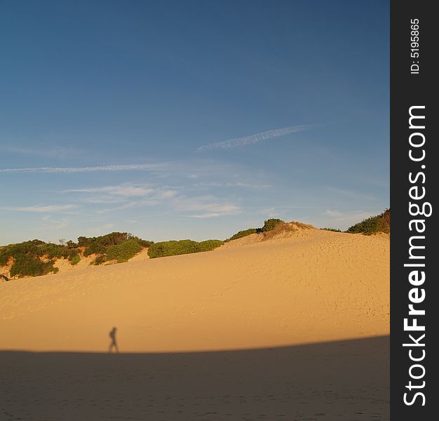 Backpacker on hot sand desert