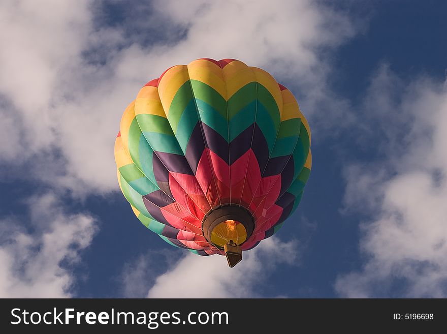 A brightly colored hot air balloon shot from below