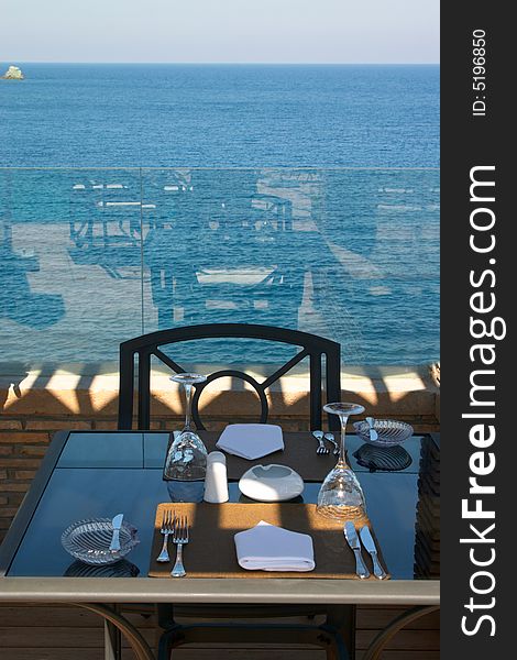 Layed table in restaurant near of sea. Layed table in restaurant near of sea