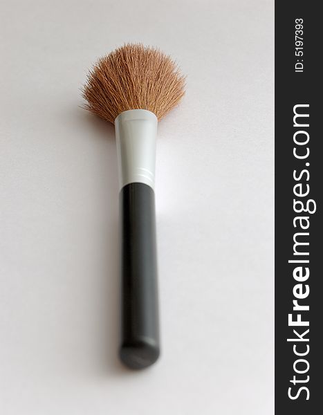 Make up brush on gray background