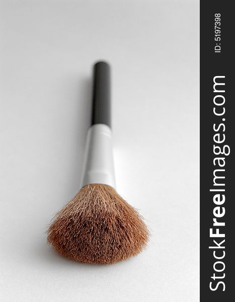 Make up brush on gray background