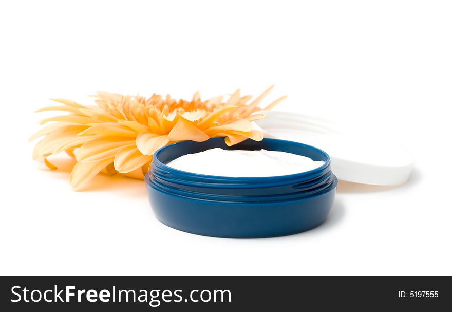 Moisturizing cream with orange gerbera close up