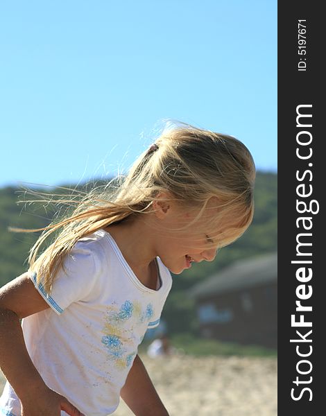 A beautiful white caucasian girl child enjoying the beach. A beautiful white caucasian girl child enjoying the beach