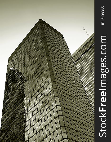 Monochrome image of a tall, modern office building. Monochrome image of a tall, modern office building.