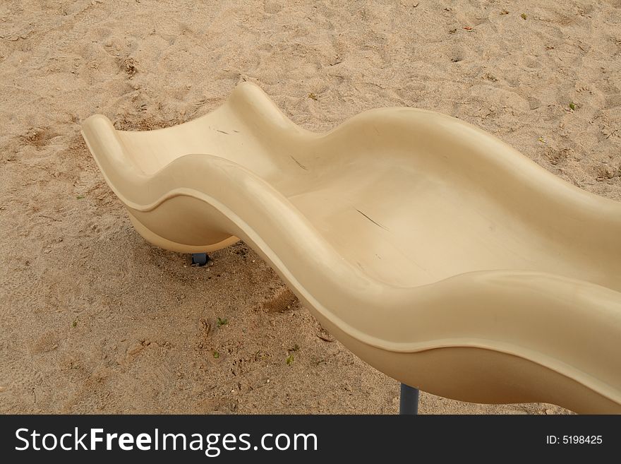 Top view of a slider on a sand playground