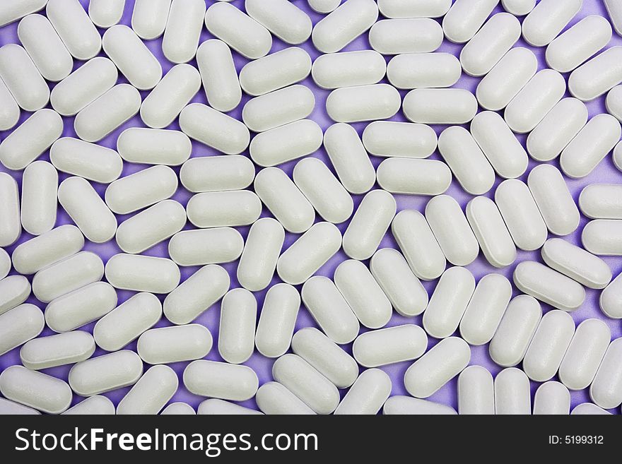 Many white pills as an abstract background