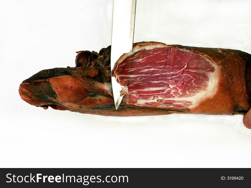 Piece of meat with knife over white background. Piece of meat with knife over white background