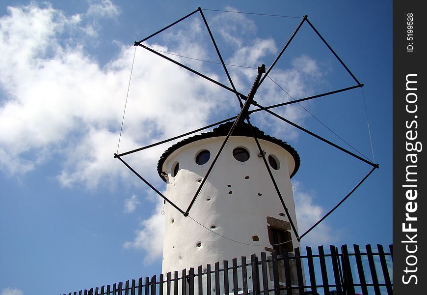 White windmill against blue sky