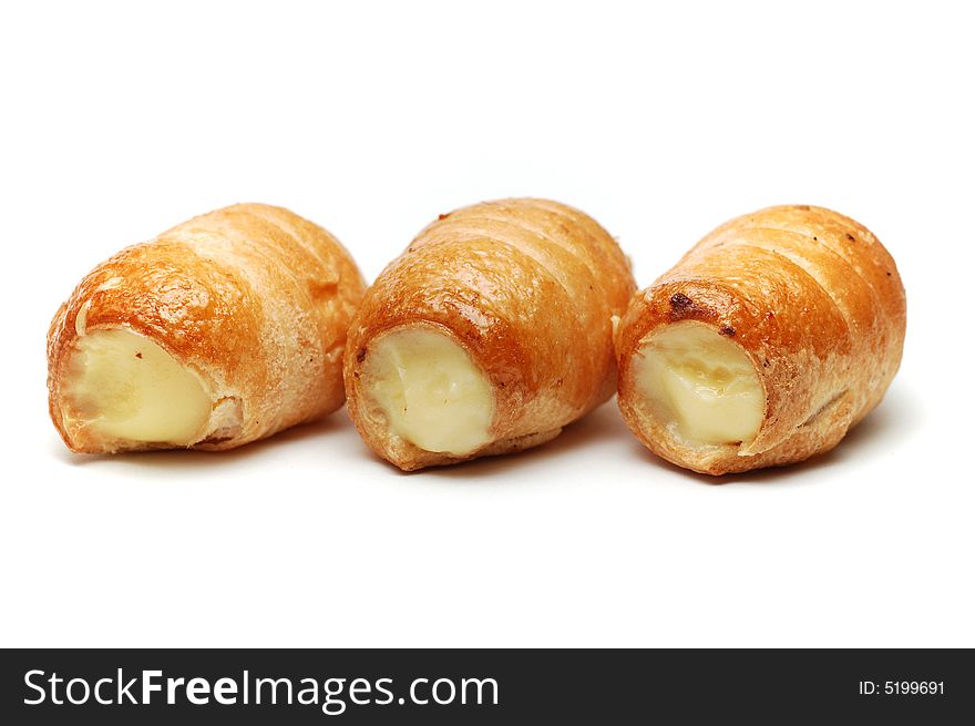 Three cream pastries isolated over white background