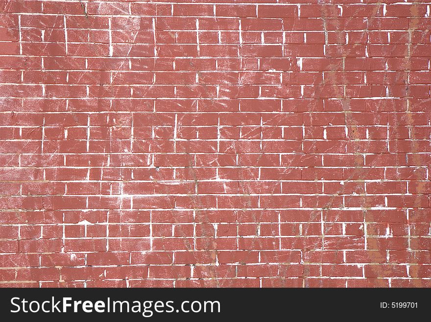 An old scarred and beat up brick wall for background or texture