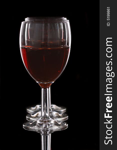 Wineglasses with red wine in row in black