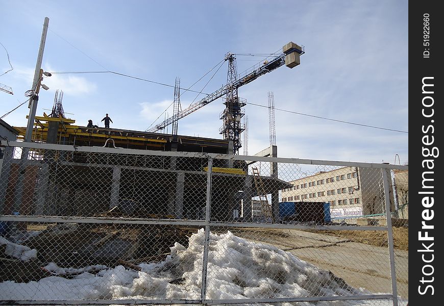 Construction crane working at a height of several tens of meters above the ground. Construction crane working at a height of several tens of meters above the ground.