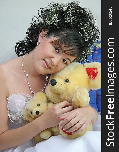 Bride with soft Ð¸Ñ€ÑƒÑˆÐºÐ¾Ð¹ sits on sofa. Bride with soft Ð¸Ñ€ÑƒÑˆÐºÐ¾Ð¹ sits on sofa