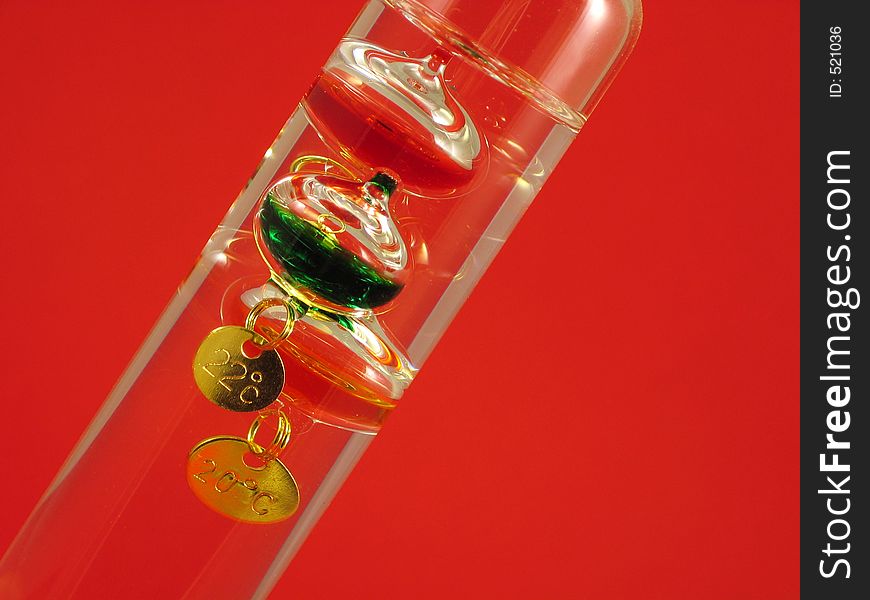 Galilean thermometer on re background in diagonal angle