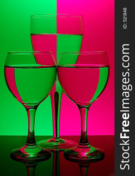 Three glasses on neon background