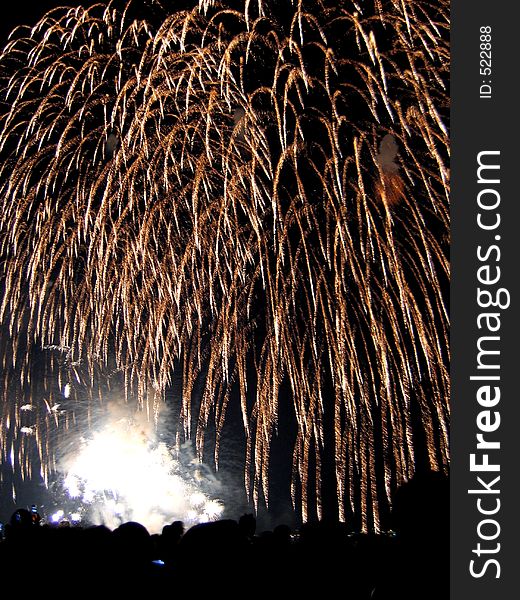 Fireworks display over a crowd. Fireworks display over a crowd