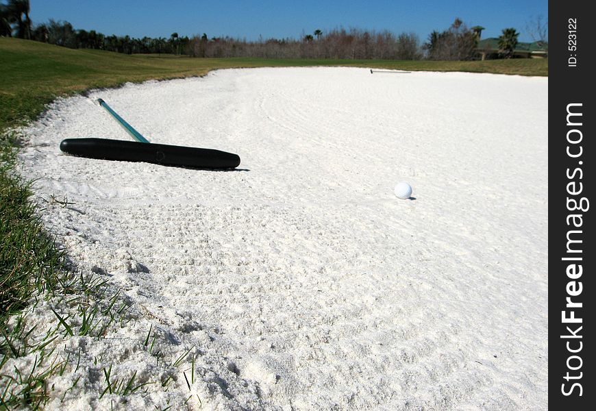 Orignal image of a golf ball in a sand bunker.