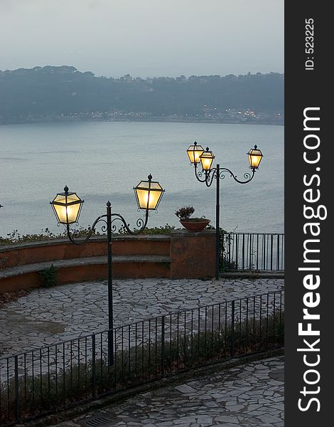 Lampposts and terrace with view on lake. Lampposts and terrace with view on lake