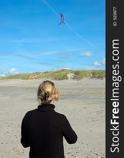 Kiting on the beach, blue sky