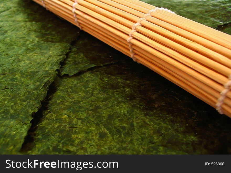 Bamboo sushi mat (used for making sushi) and nori (seaweed). Bamboo sushi mat (used for making sushi) and nori (seaweed).